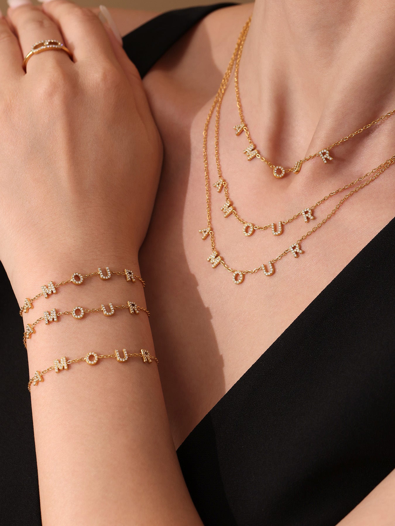 Gold jewelry set with necklaces and bracelets on a black background