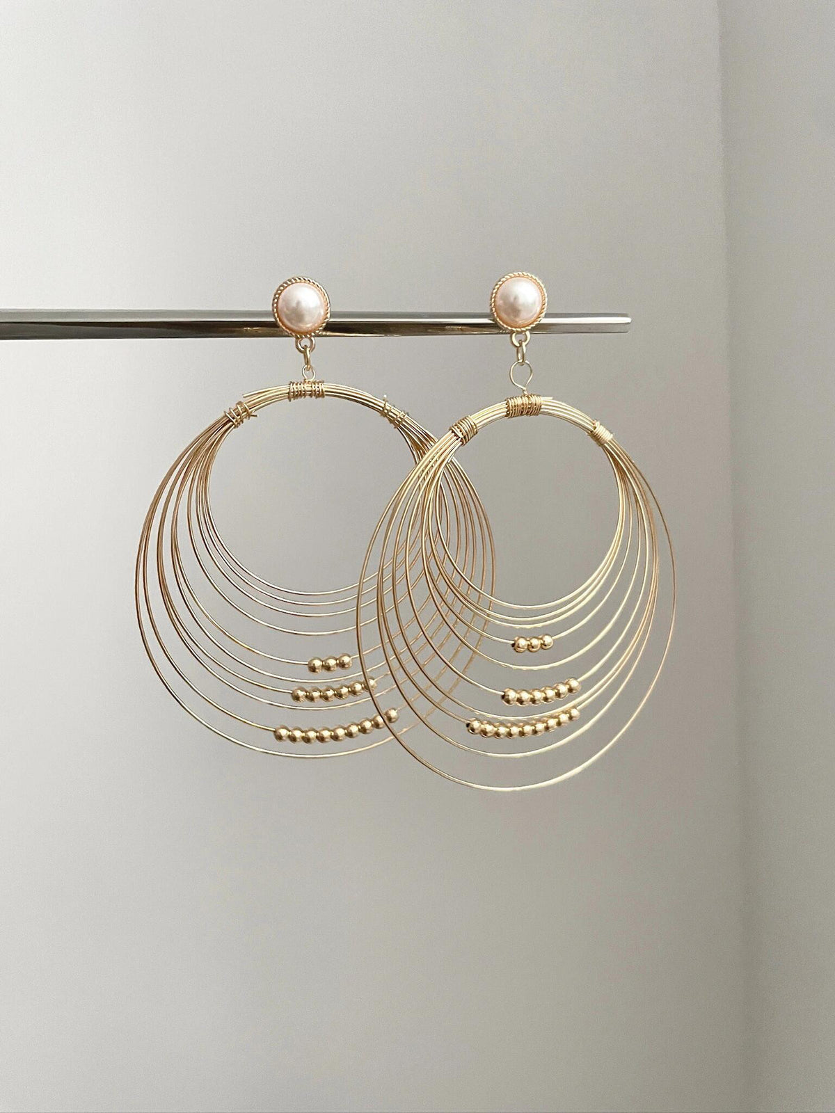 Gold coil pearl earring